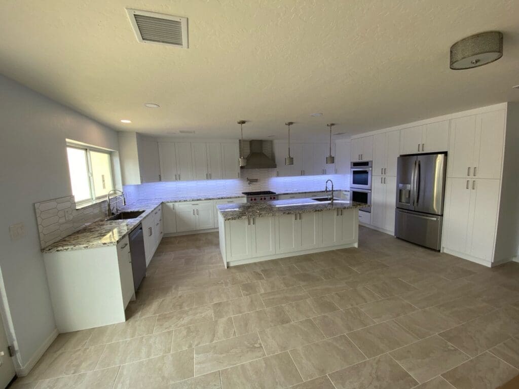 Full room view of expanded kitchen and dining area with tile flooring